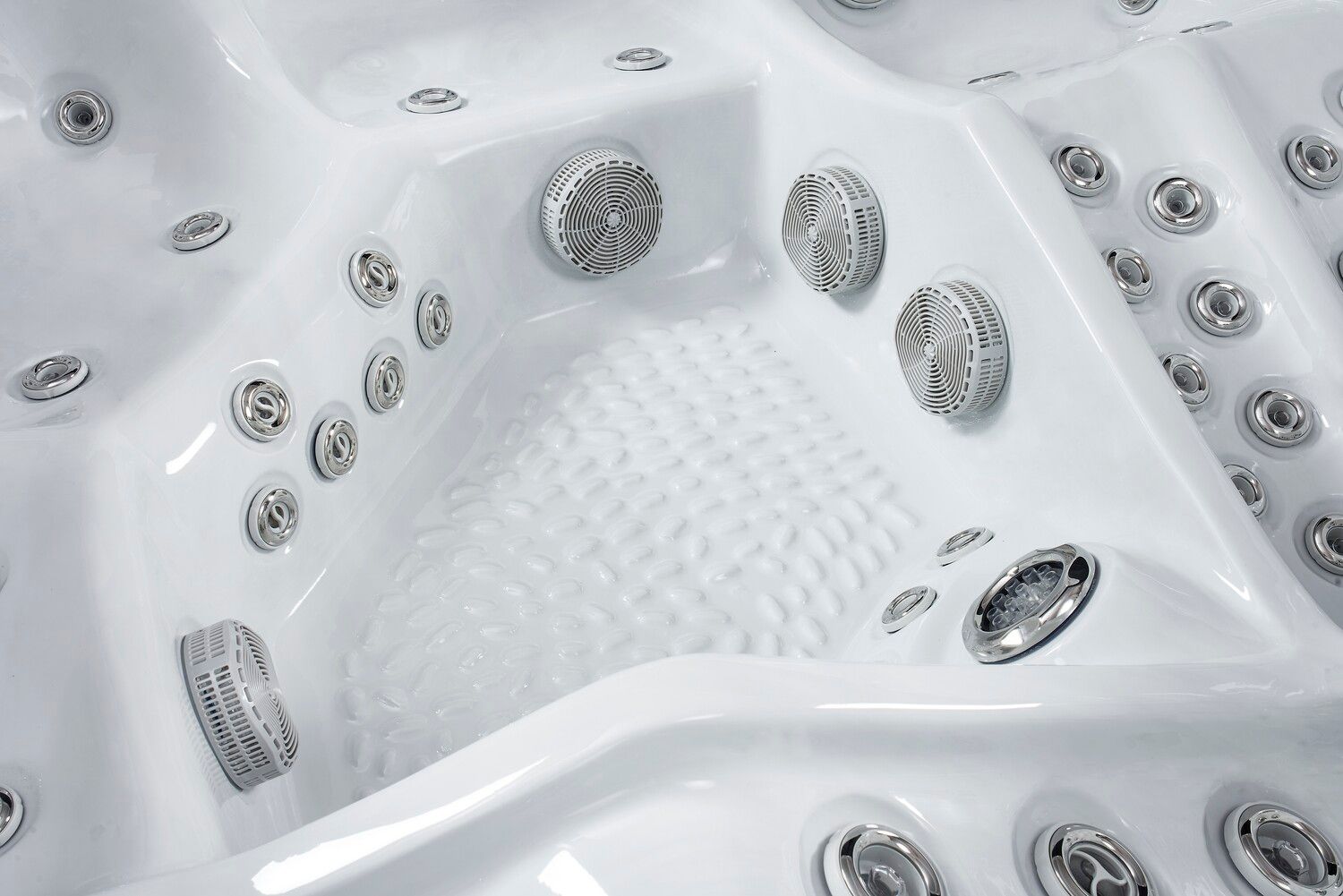 White hot tub interior with various water jets and seating areas.