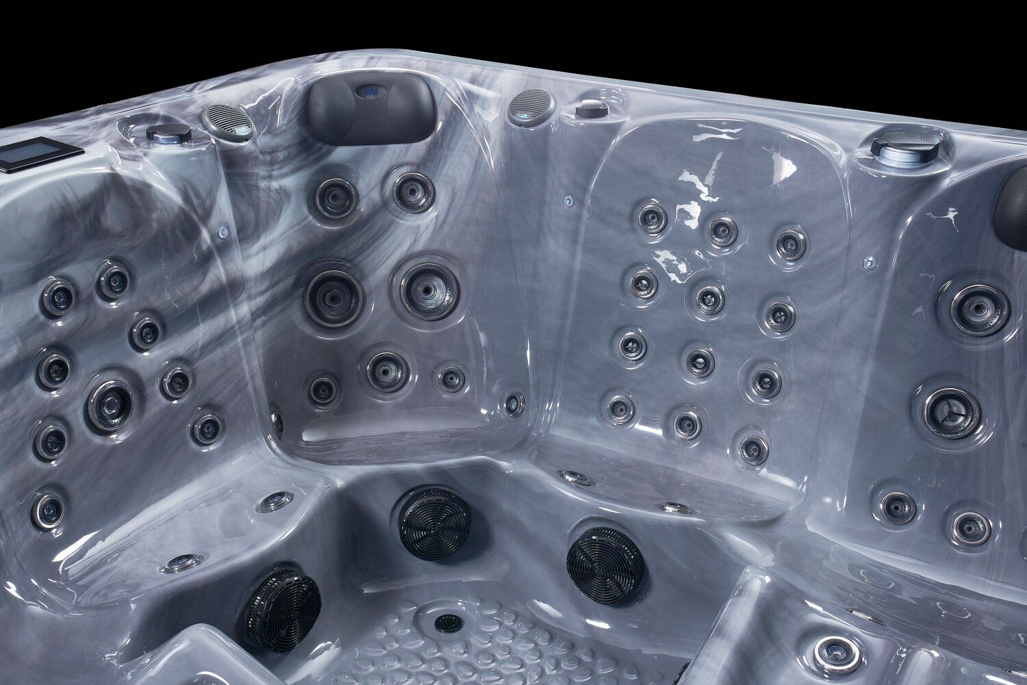 Close-up of a gray marbled hot tub interior with various jets and seating areas.