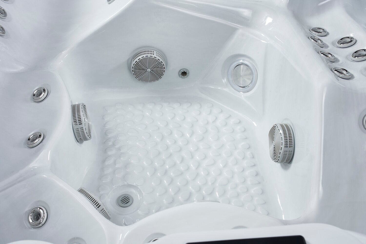 White hot tub interior with jets and textured floor.