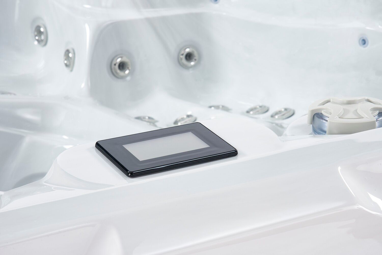 Hot tub interior with a digital control panel.