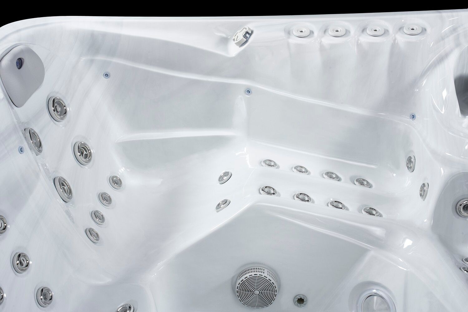 White hot tub interior with multiple jet nozzles and seating areas.