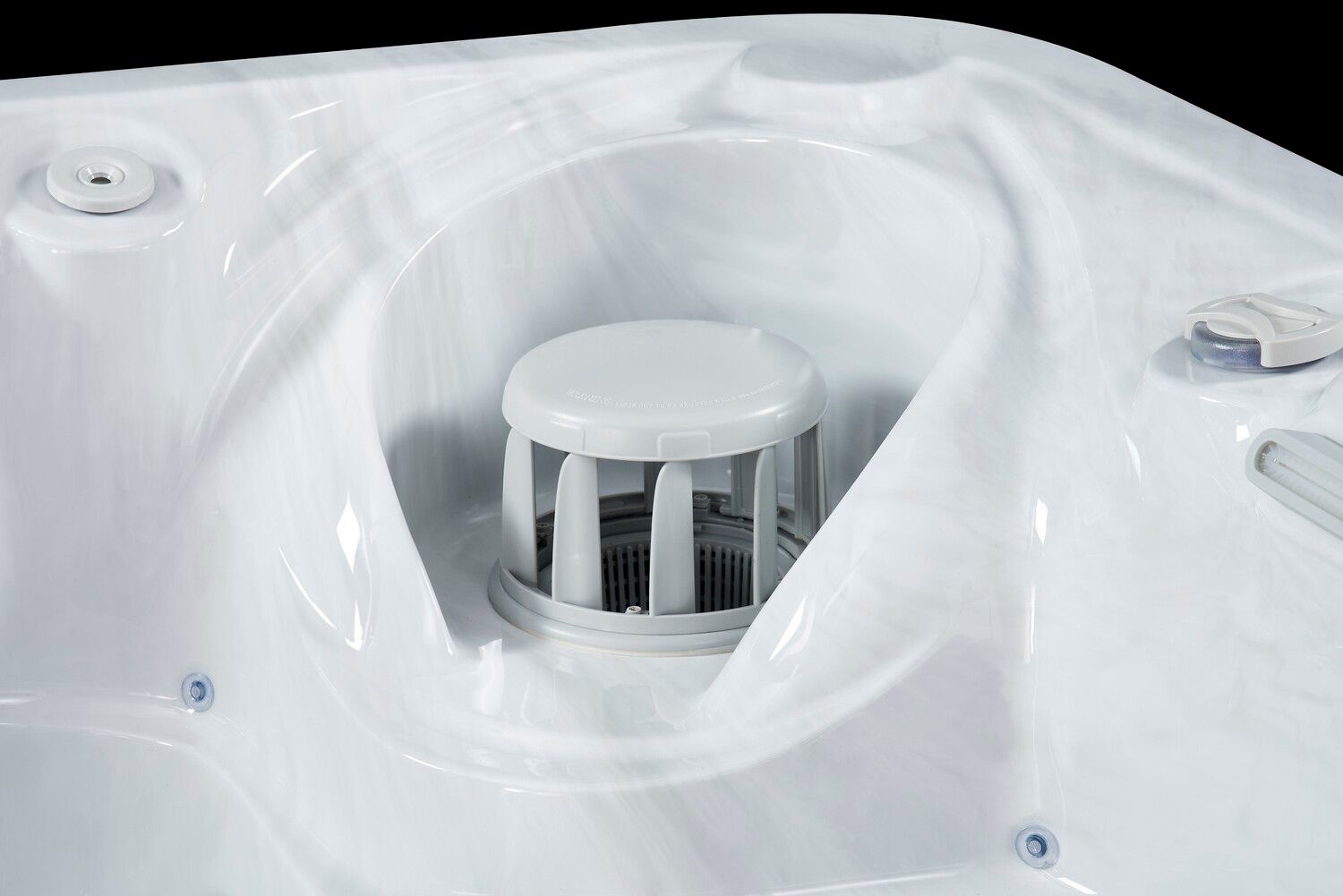 Close-up of a white hot tub interior with a cylindrical filter housing.