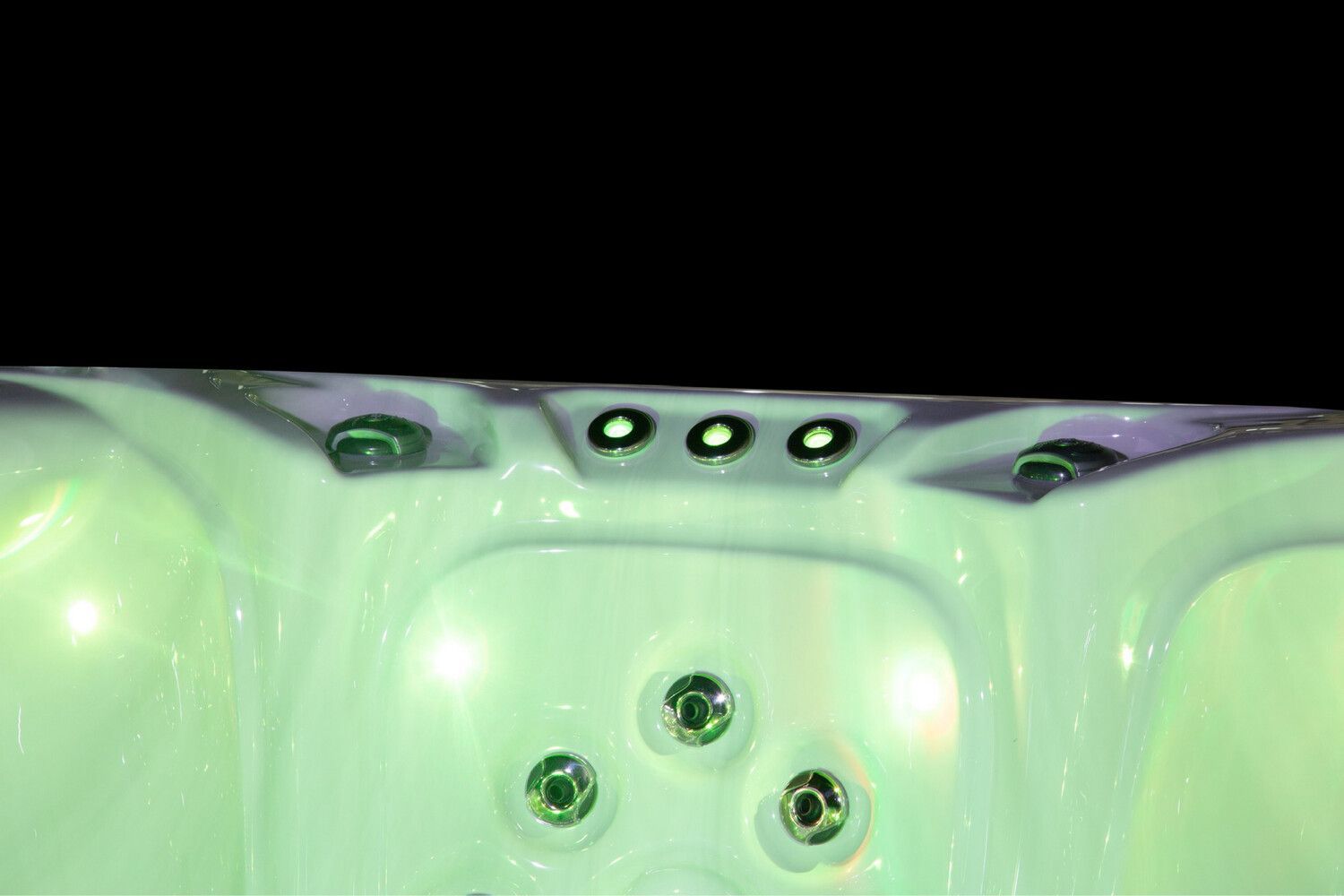 Close-up of a hot tub interior with glowing green lights and jets.