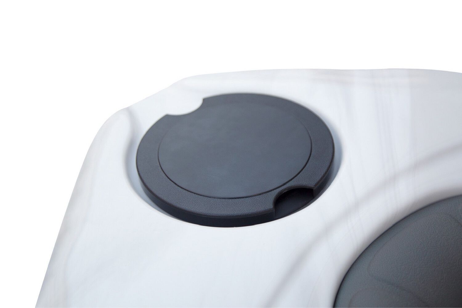 Gray circular lid set in a white plastic surface, possibly a tank or container.