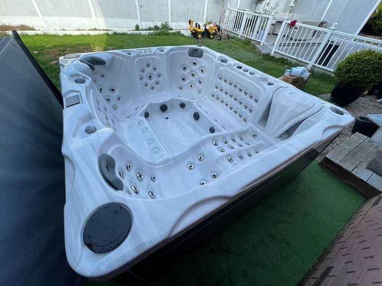 Triangular hot tub in a backyard setting.