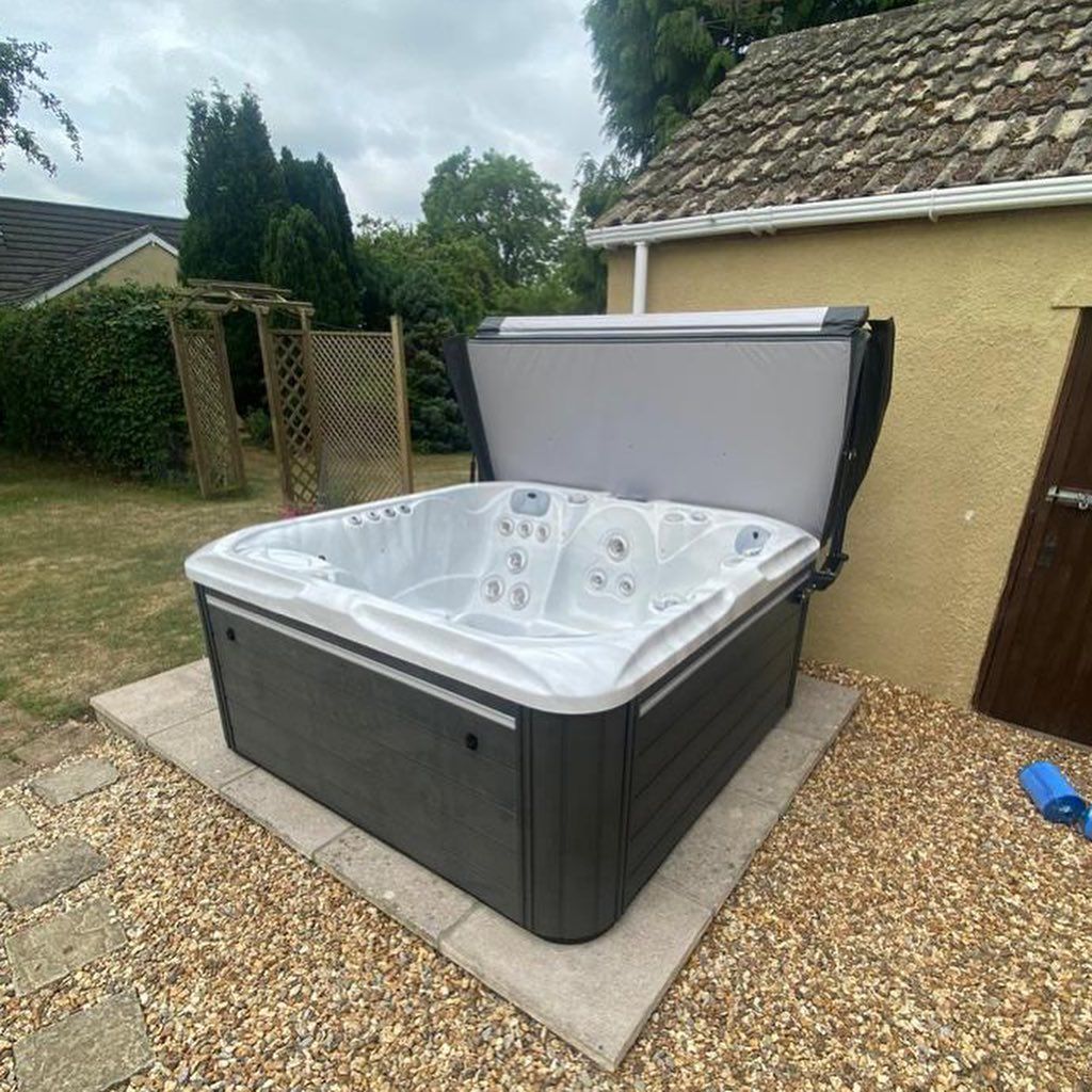 Hot tub with open cover, set on 