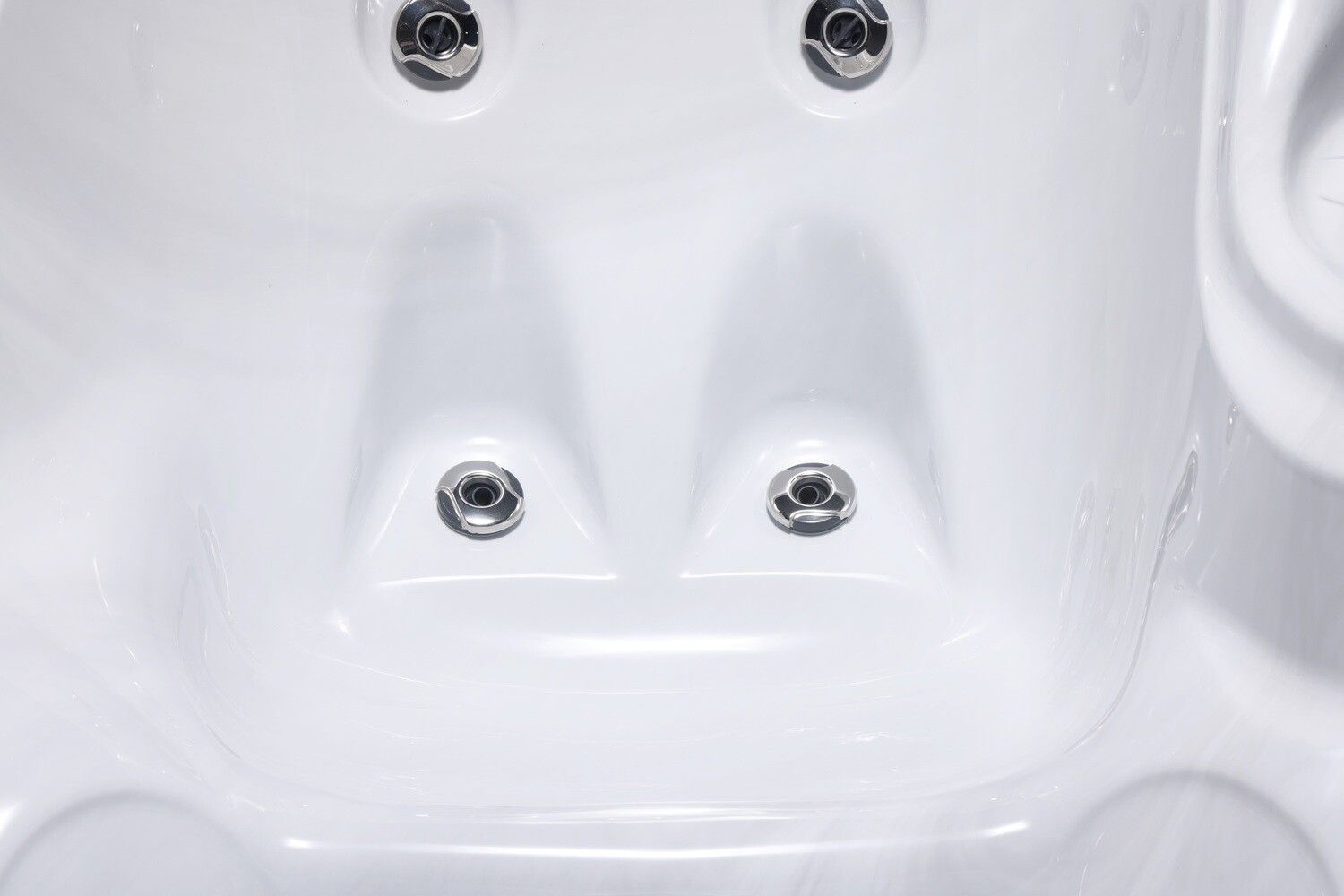 White hot tub interior with four jets, overhead view.
