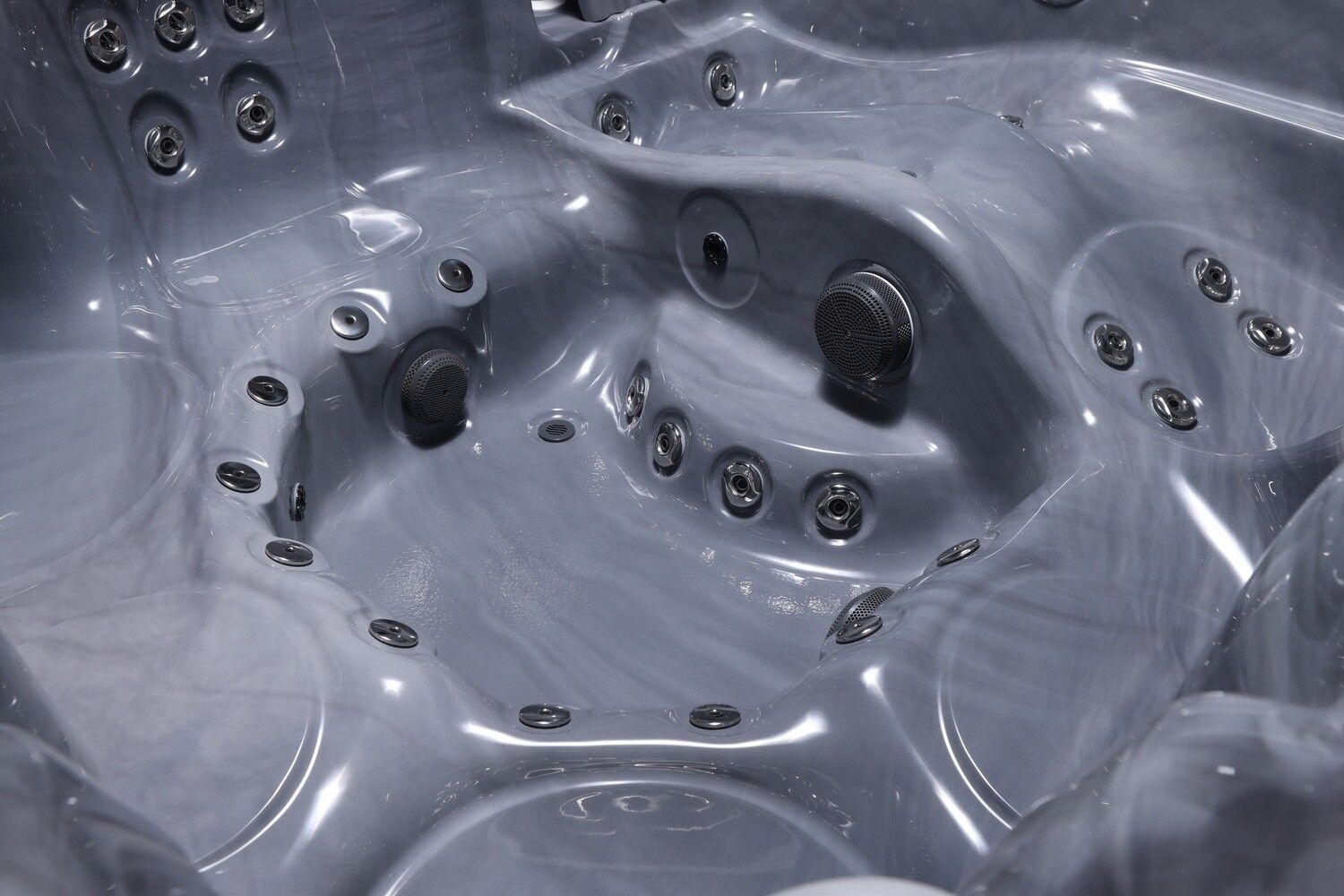 Close-up of a gray hot tub interior with several jets.