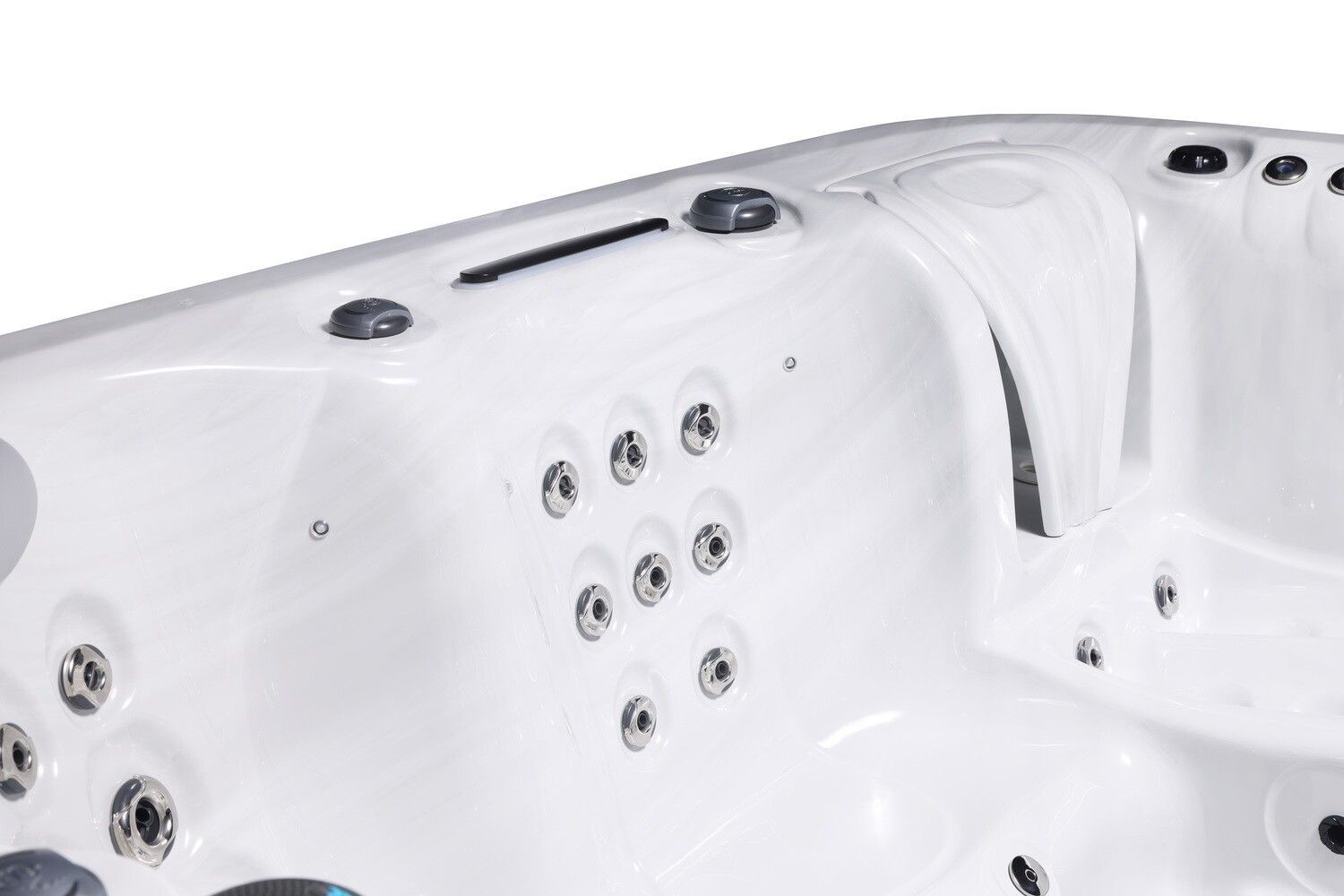Close-up of white hot tub interior with multiple jet nozzles and rounded edges.
