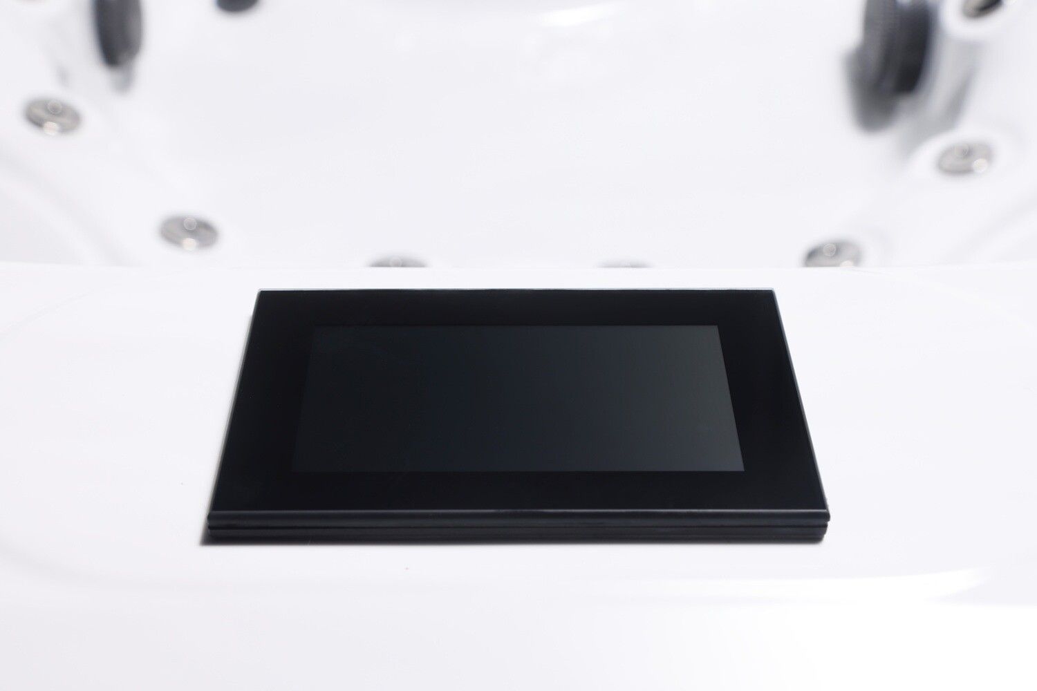 Black touch screen panel on a white hot tub surface.