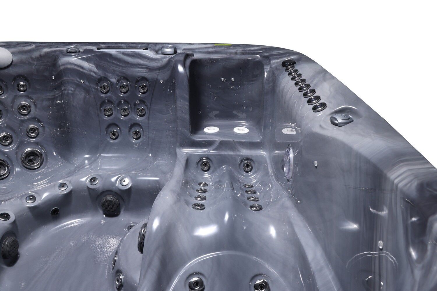 Close-up of a dark grey hot tub interior with multiple water jets, rounded seating, and marbled texture.