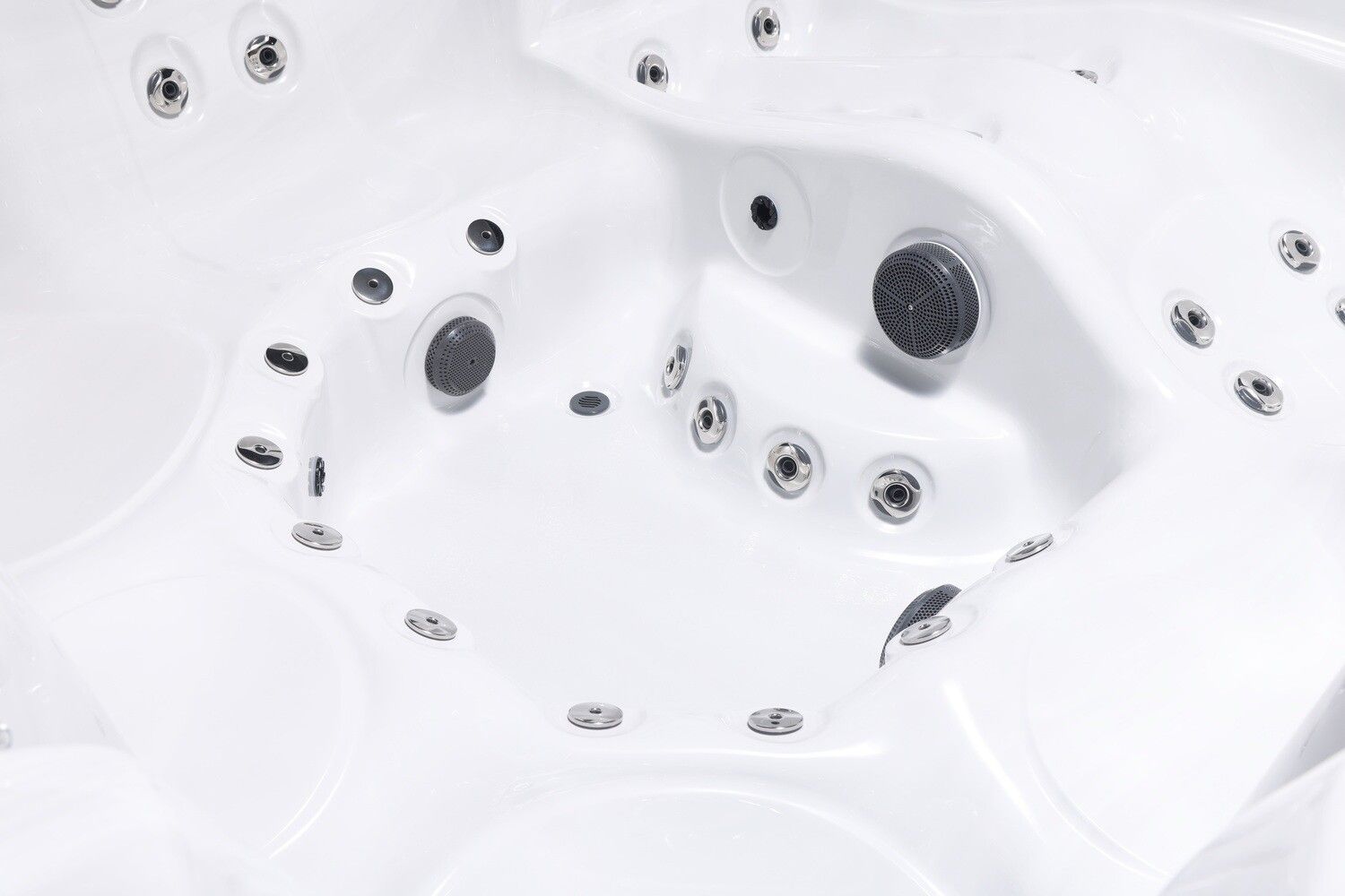 Close-up view of a white hot tub interior with multiple jet nozzles and seat contours.