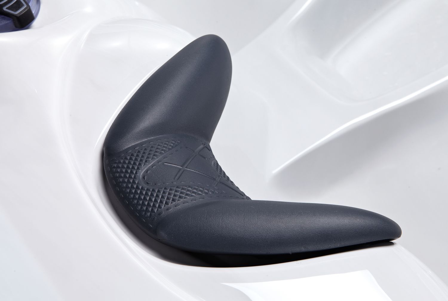 Gray ergonomic spa seat within a white spa.