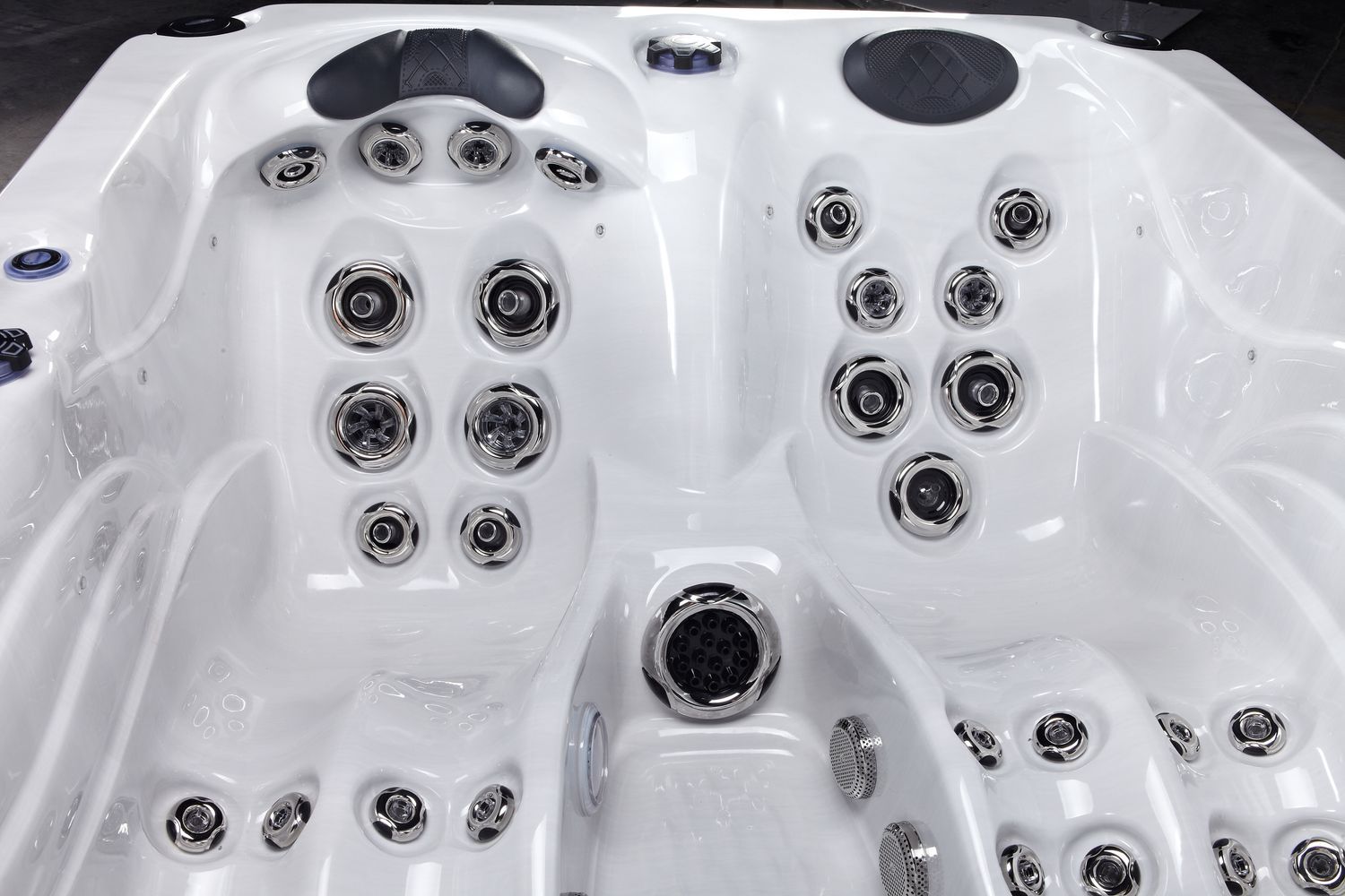 White hot tub interior with multiple jets and seating areas.