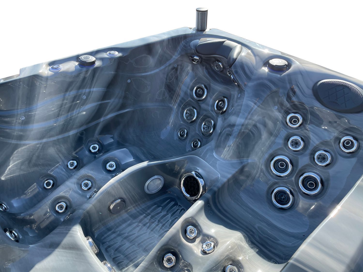 Close-up of a dark blue and gray marbled hot tub interior with several jets.