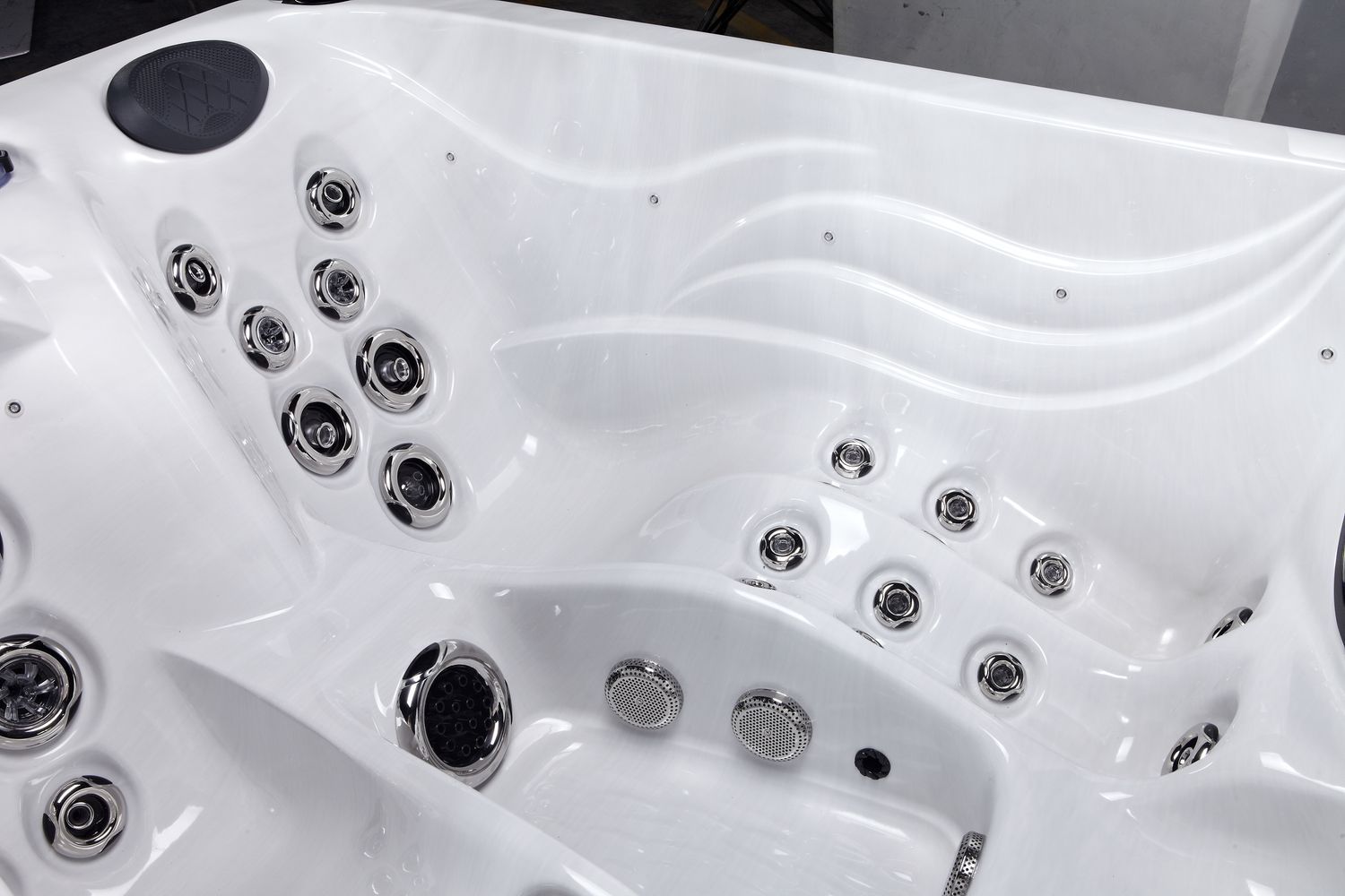 White hot tub interior with multiple jet nozzles.