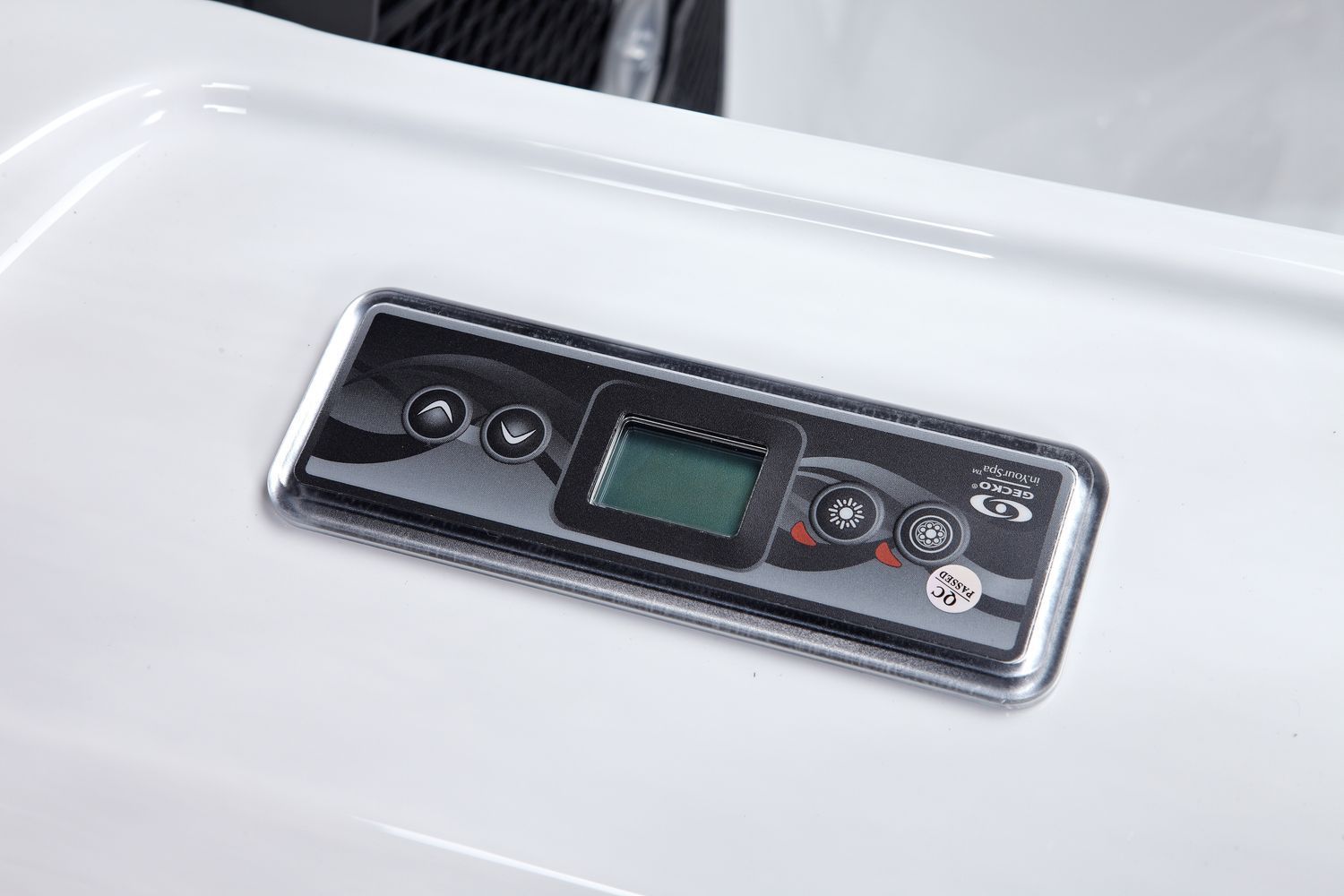 Control panel with a digital display, buttons, and a chrome frame embedded in a white surface.