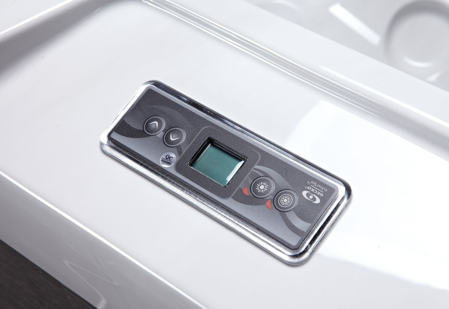 Jacuzzi control panel with LCD screen, chrome trim, mounted on white spa.