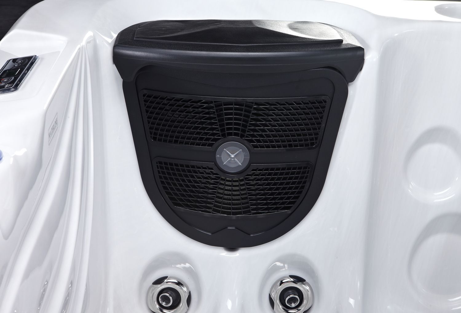 Close-up of a white hot tub interior with a black speaker grill and jets.