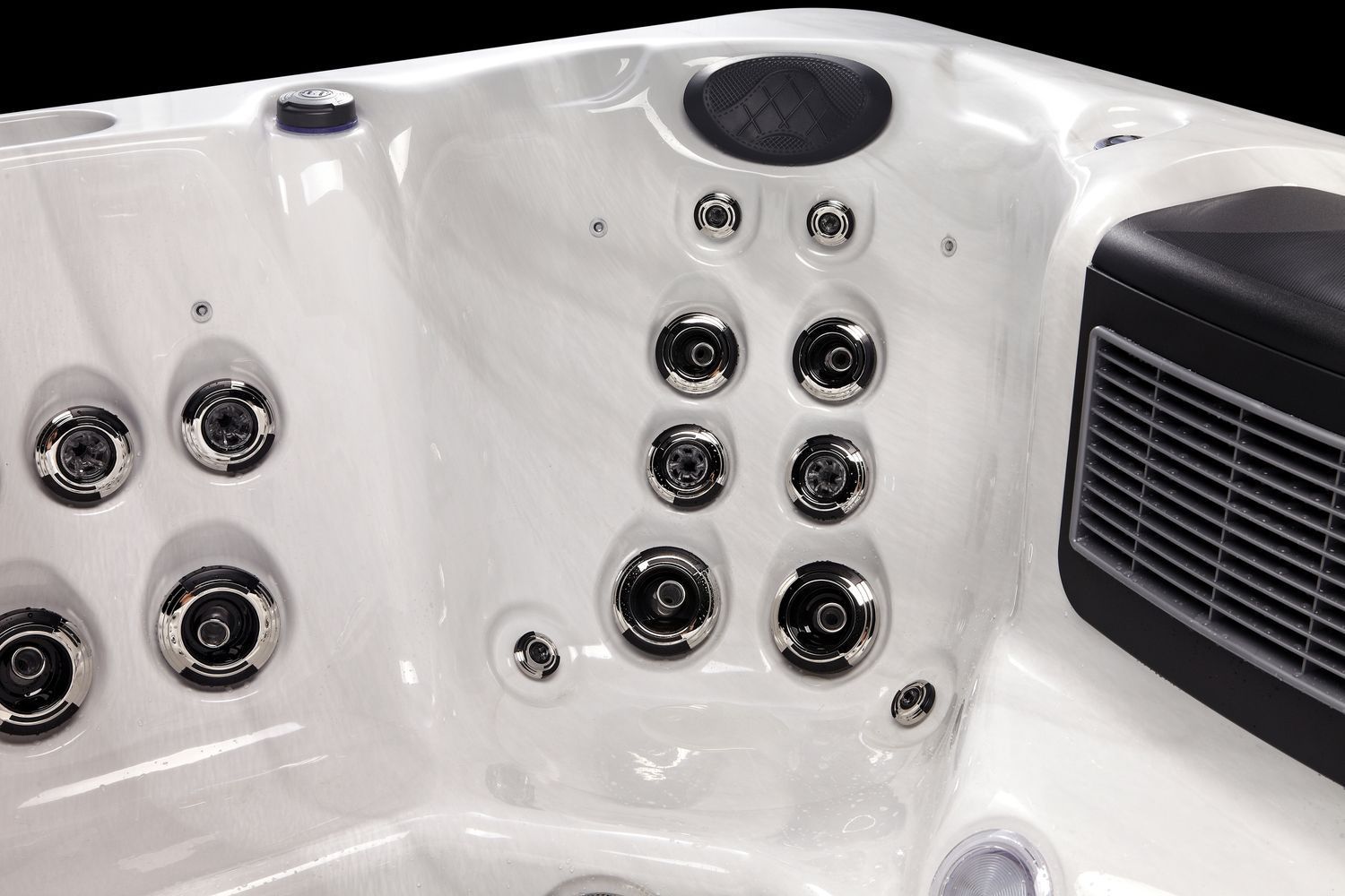 White hot tub interior with various jets and a speaker.