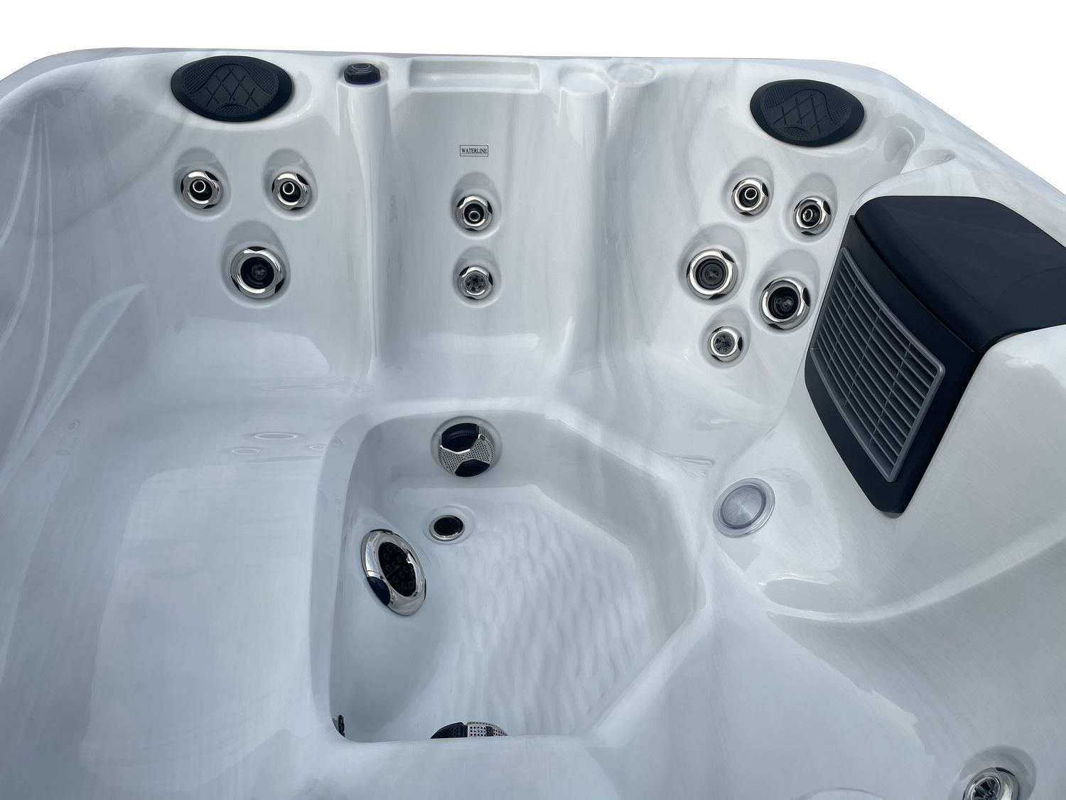 White hot tub interior with jets, control panel, and speakers.