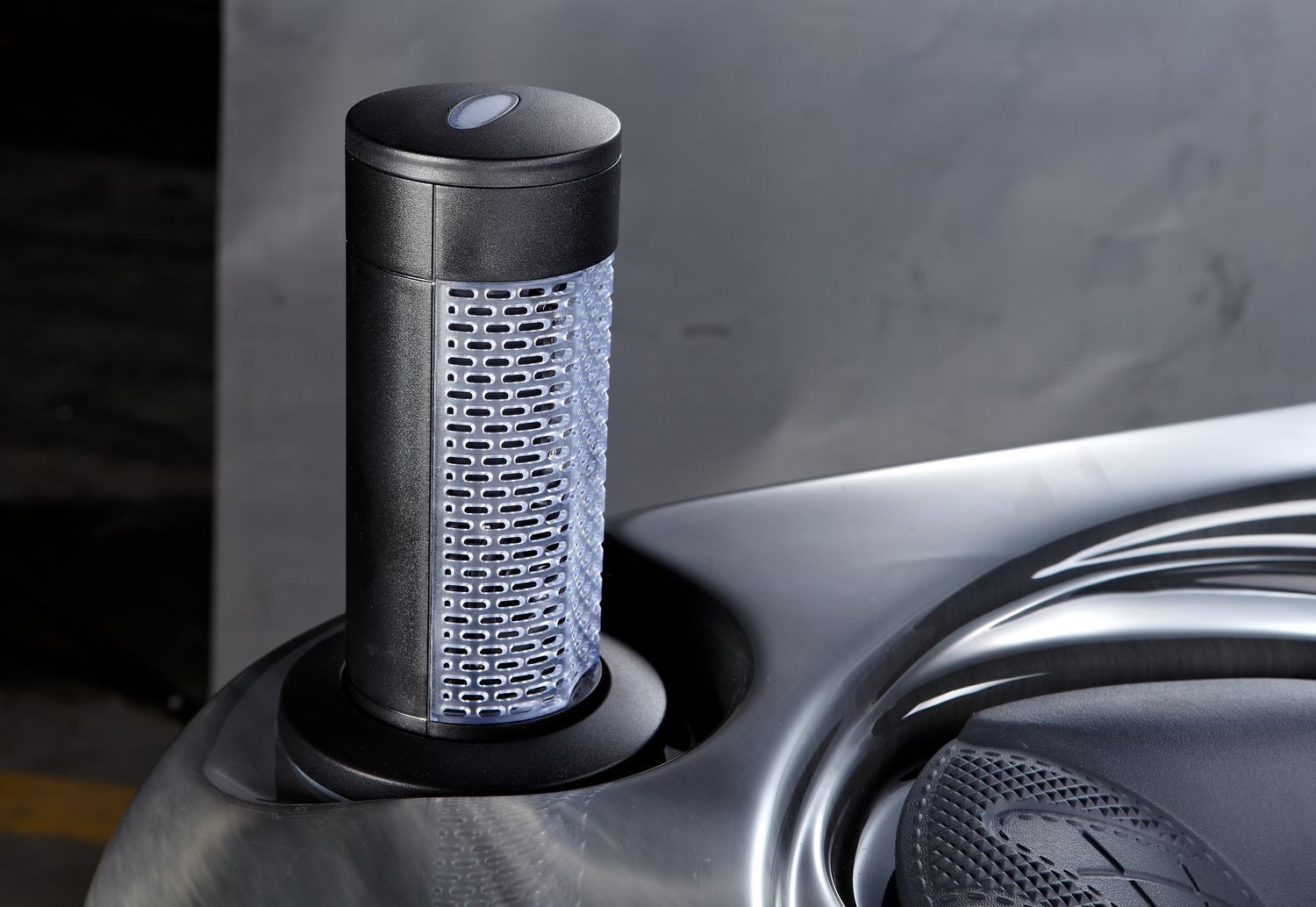 Black water cooler filter in a silver basin.