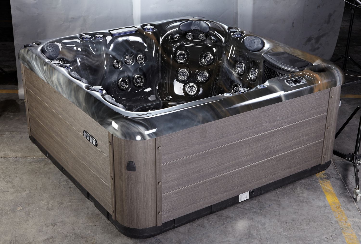 Dark brown and grey hot tub, indoor setting.