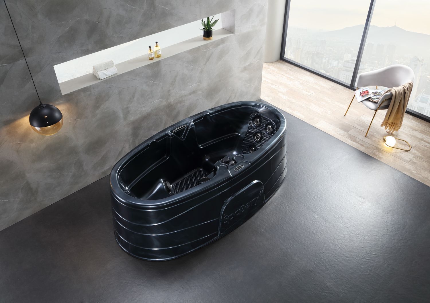 Black oval hot tub in a modern bathroom with grey walls and a large window.
