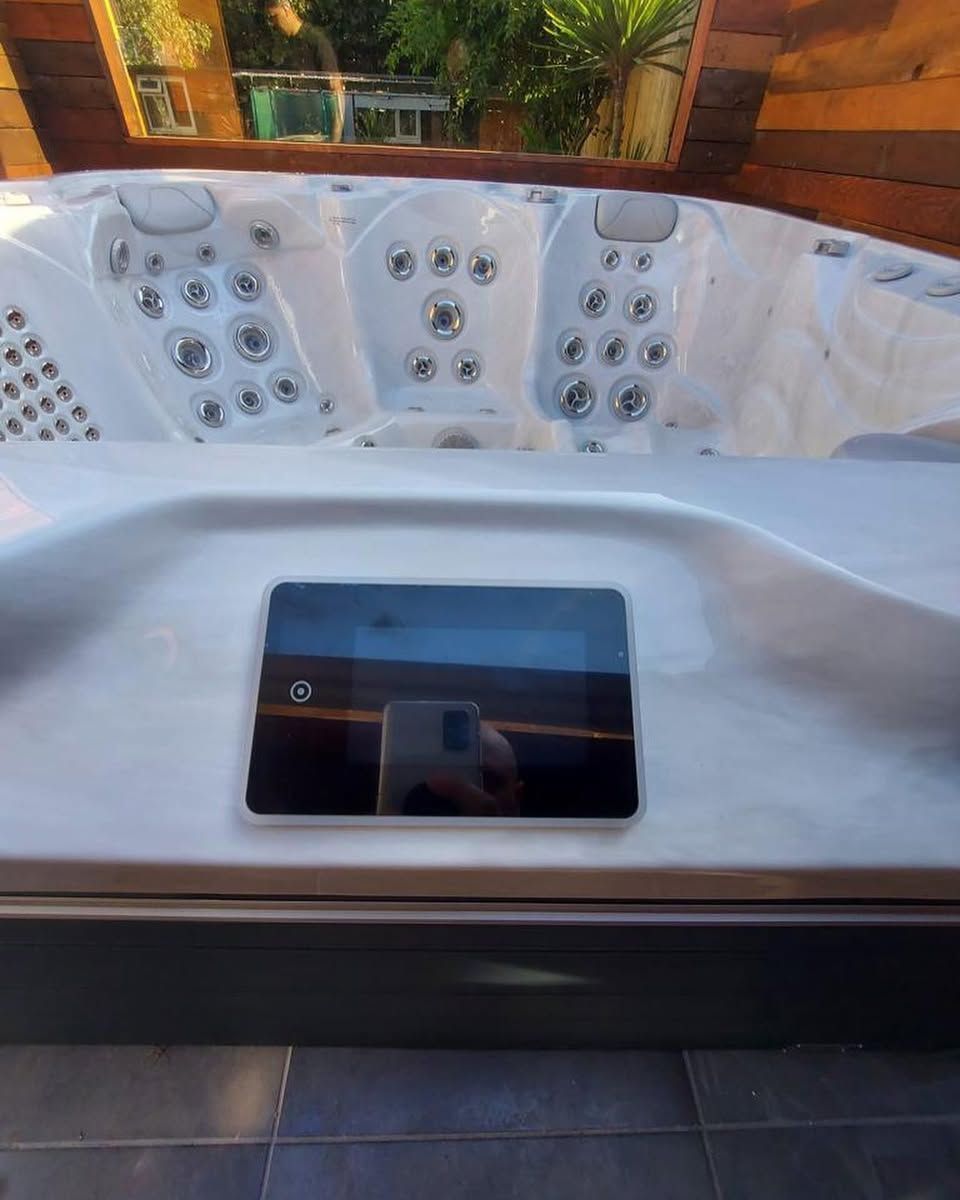 Close-up of a hot tub interior with jet controls and a digital display.