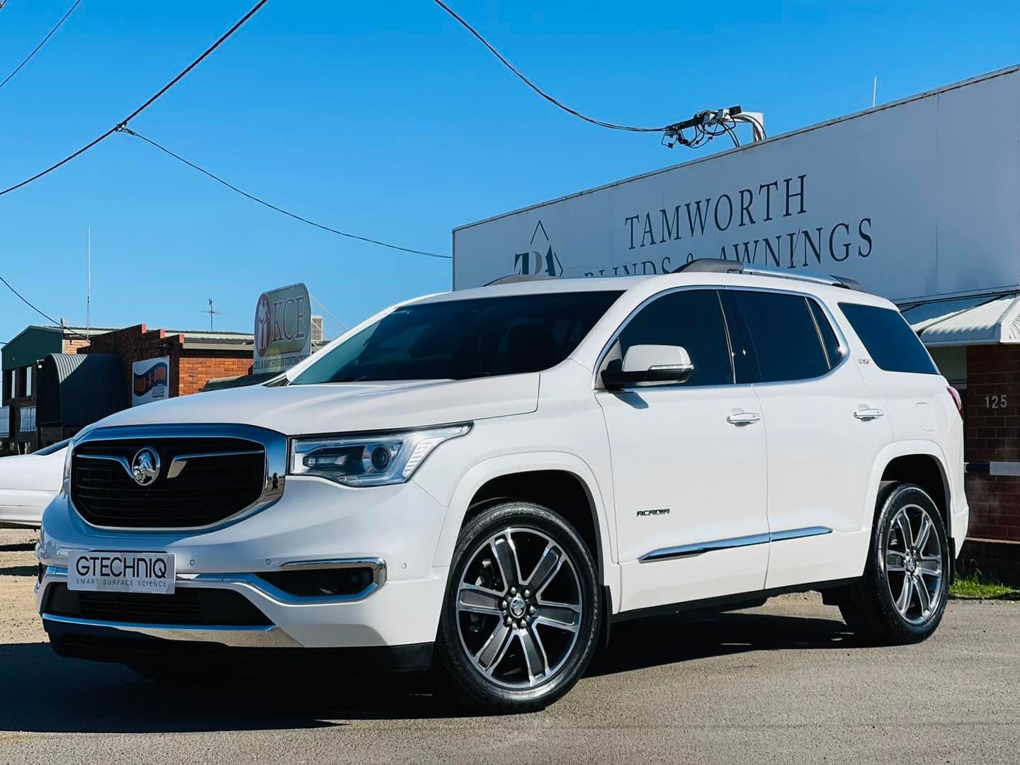 GTechniq Flag Behind the White Car — Jake’s Car Detailing in Tamworth, NSW