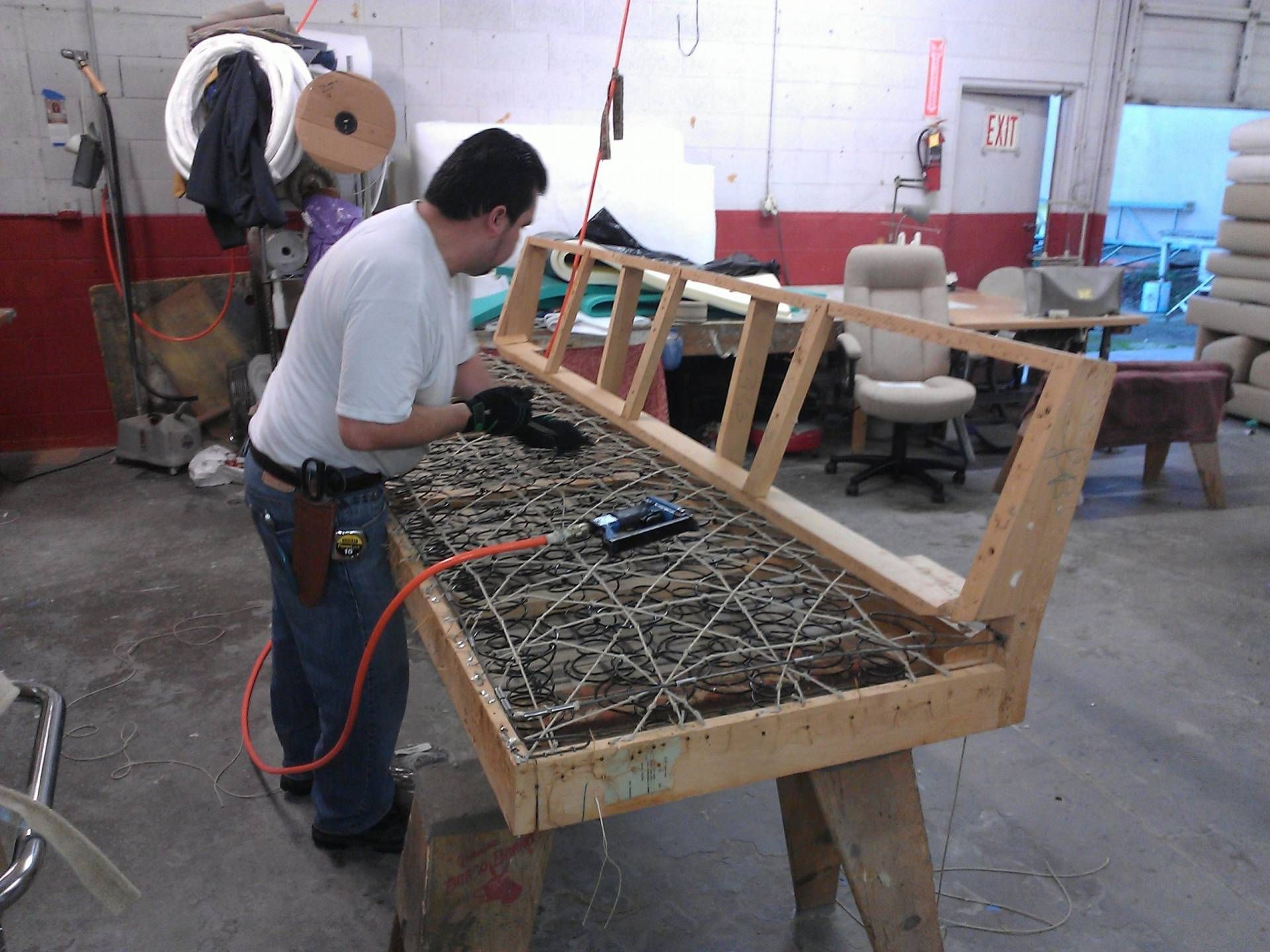 Man is Working on a Wooden Frame in a Workshop — San Jose, CA — Upholstery Specialists