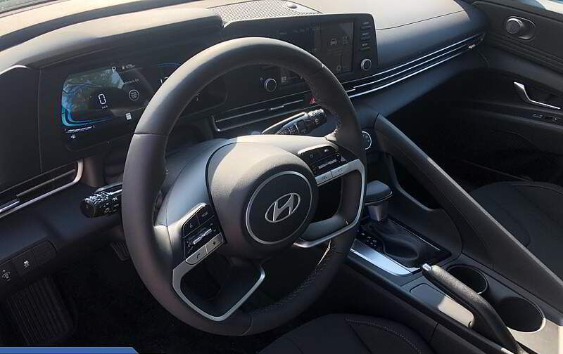 Interior view of a Hyundai car, focusing on the steering wheel, dashboard, and console.