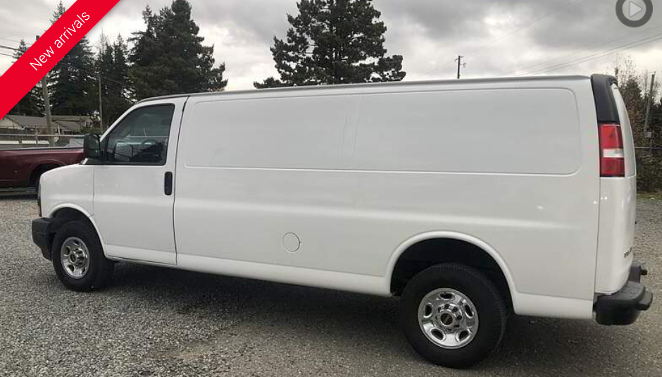 White cargo van parked outdoors. 