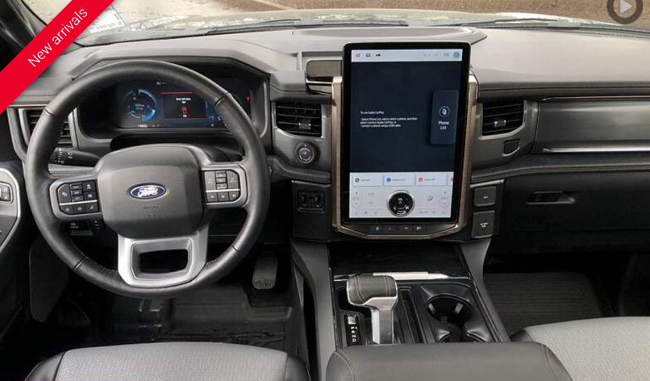 Interior view of a Ford truck dashboard with a large central touchscreen and digital instrument panel.