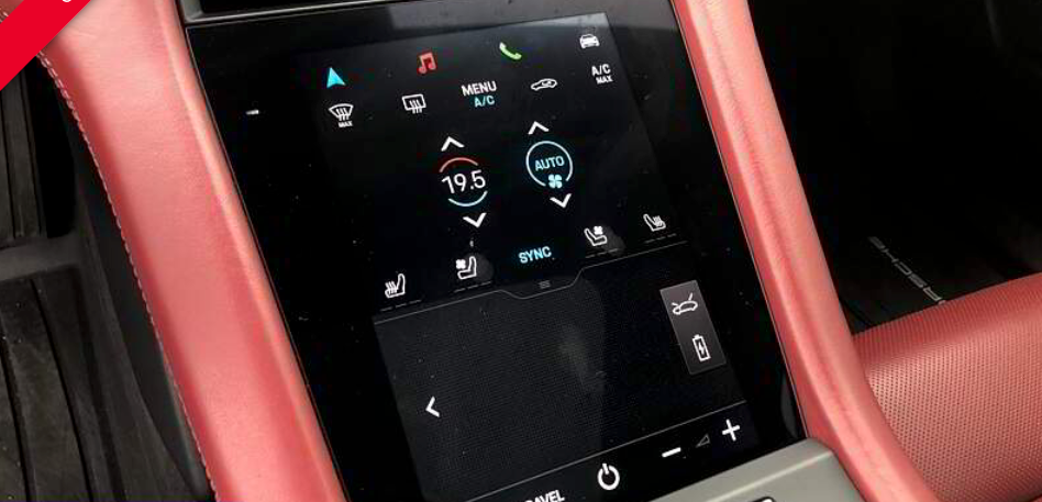 Car's dashboard screen displaying climate controls; red and black interior; touch screen controls.