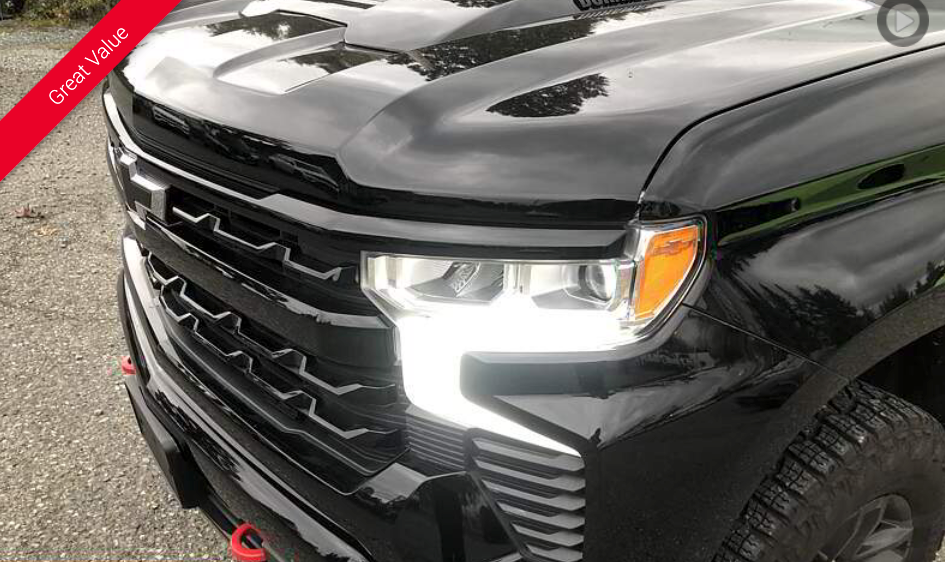 Black Chevy truck with grill and headlight detail; red 