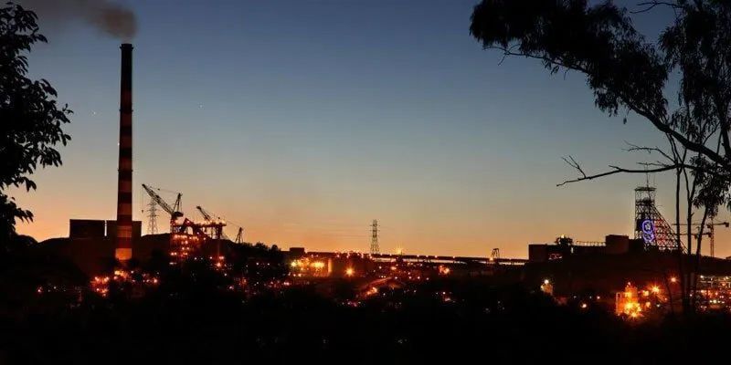 A Factory At Night With Smoke Coming Out Of The Chimney — Leichhardt Accommodation in Mornington, QLD