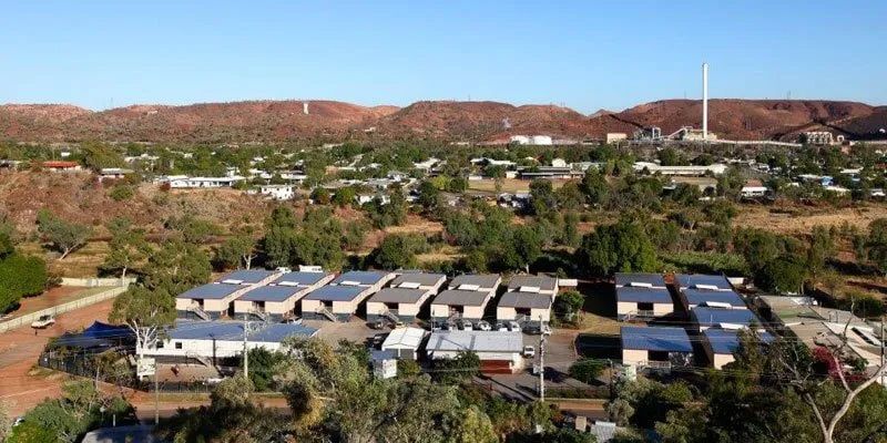 An Aerial View Of A Small Town With Mountains In The Background — Leichhardt Accommodation in Mornington, QLD