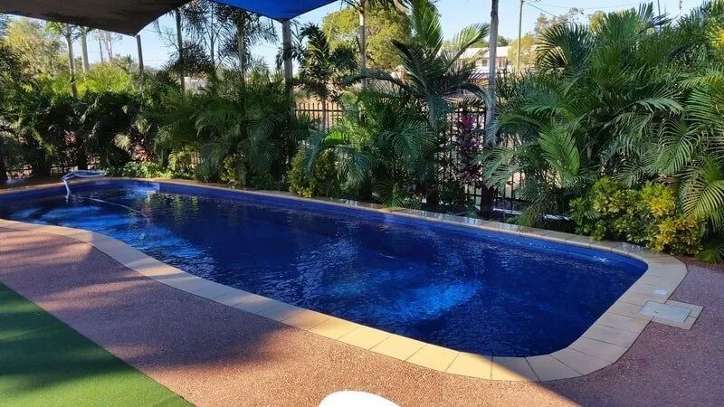 Trees And Bushes surround a Large Swimming Pool — Leichhardt Accommodation in Mornington, QLD