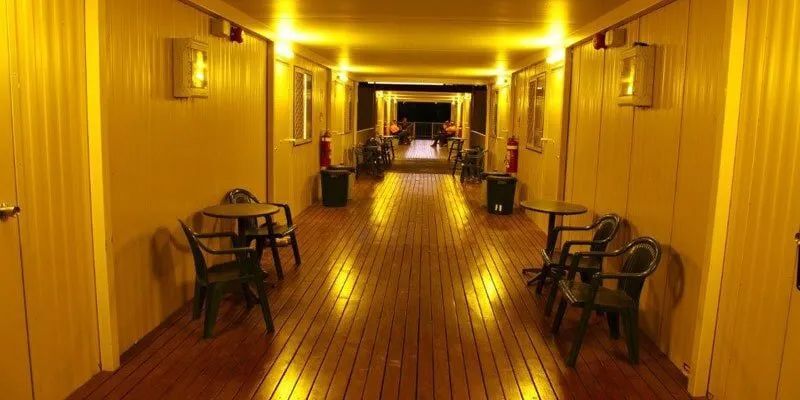 A Long Hallway With Tables And Chairs In It — Leichhardt Accommodation in Mornington, QLD