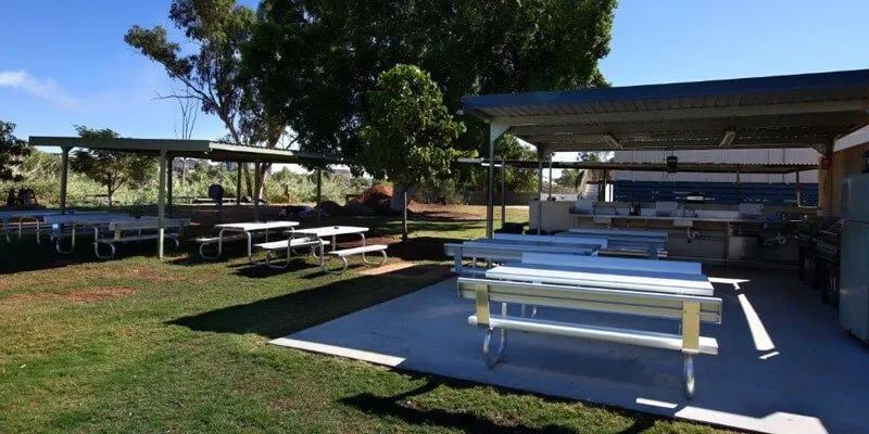 A Picnic Area With Tables And Benches Under A Canopy — Leichhardt Accommodation in Mornington, QLD