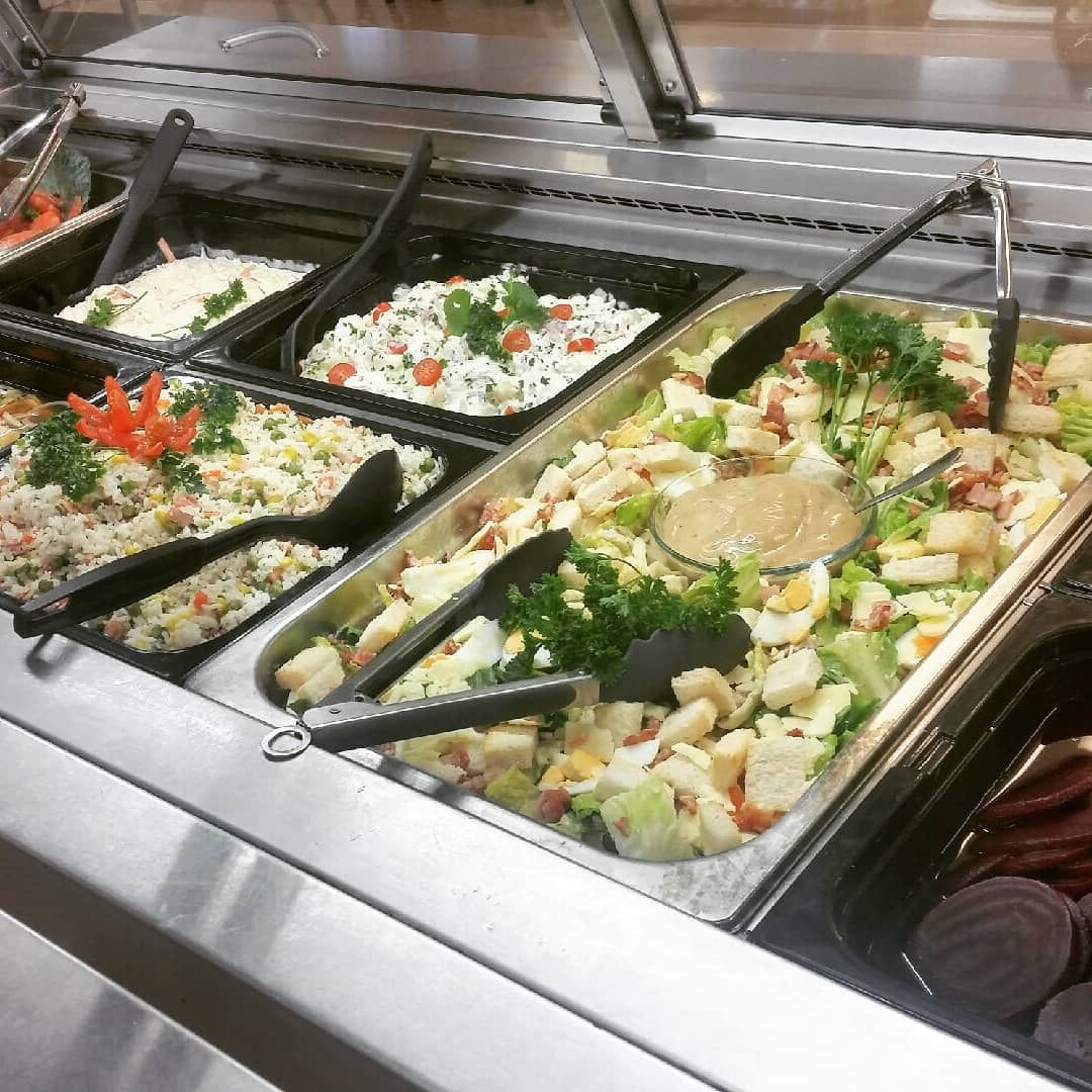 Buffet with Various Dishes in Silver Trays, People Serving Themselves — Leichhardt Accommodation in Mornington, QLD