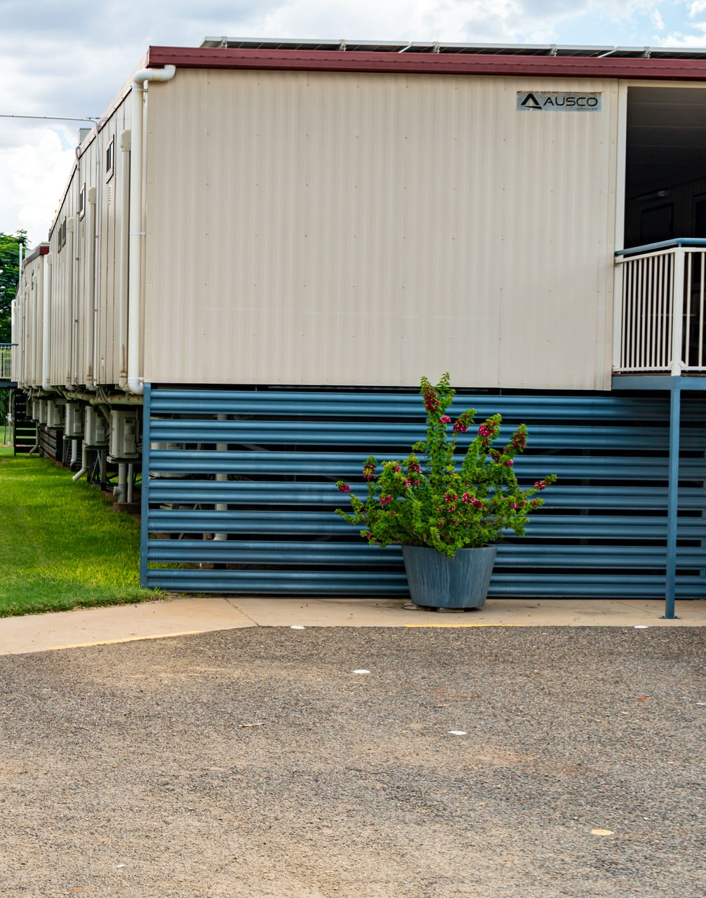 A White Van Is Parked In Front Of A Building — Leichhardt Accommodation in Mornington, QLD