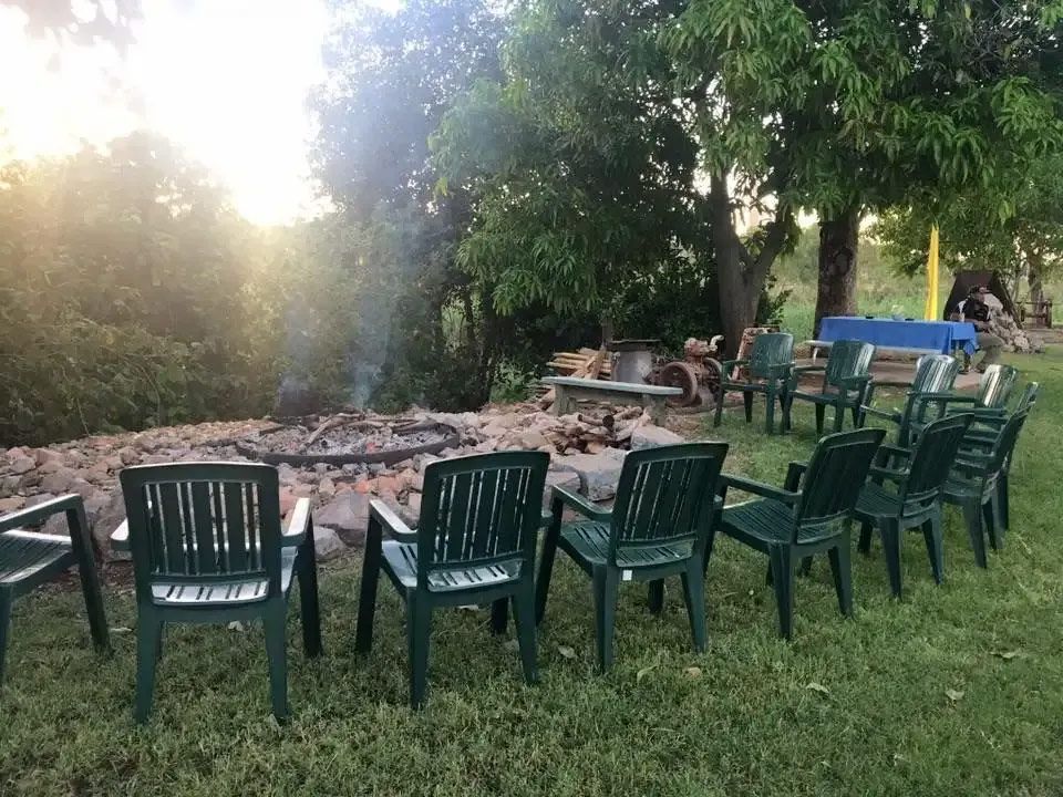 A Row Of Chairs Are Sitting In Front Of A Fire Pit — Leichhardt Accommodation in Mornington, QLD