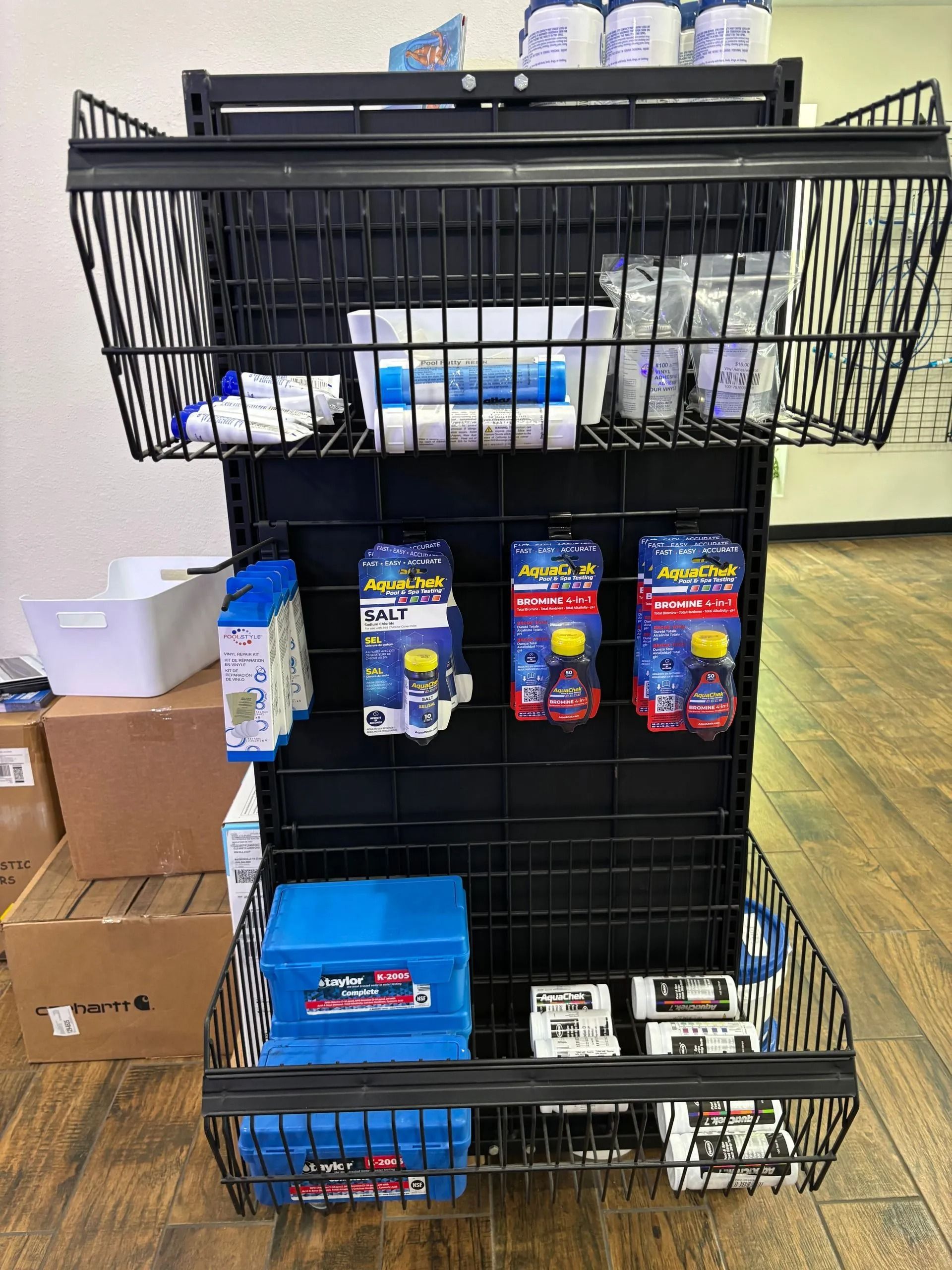 Display of packaged car cleaning products stacked on a black metal shelf in a store aisle