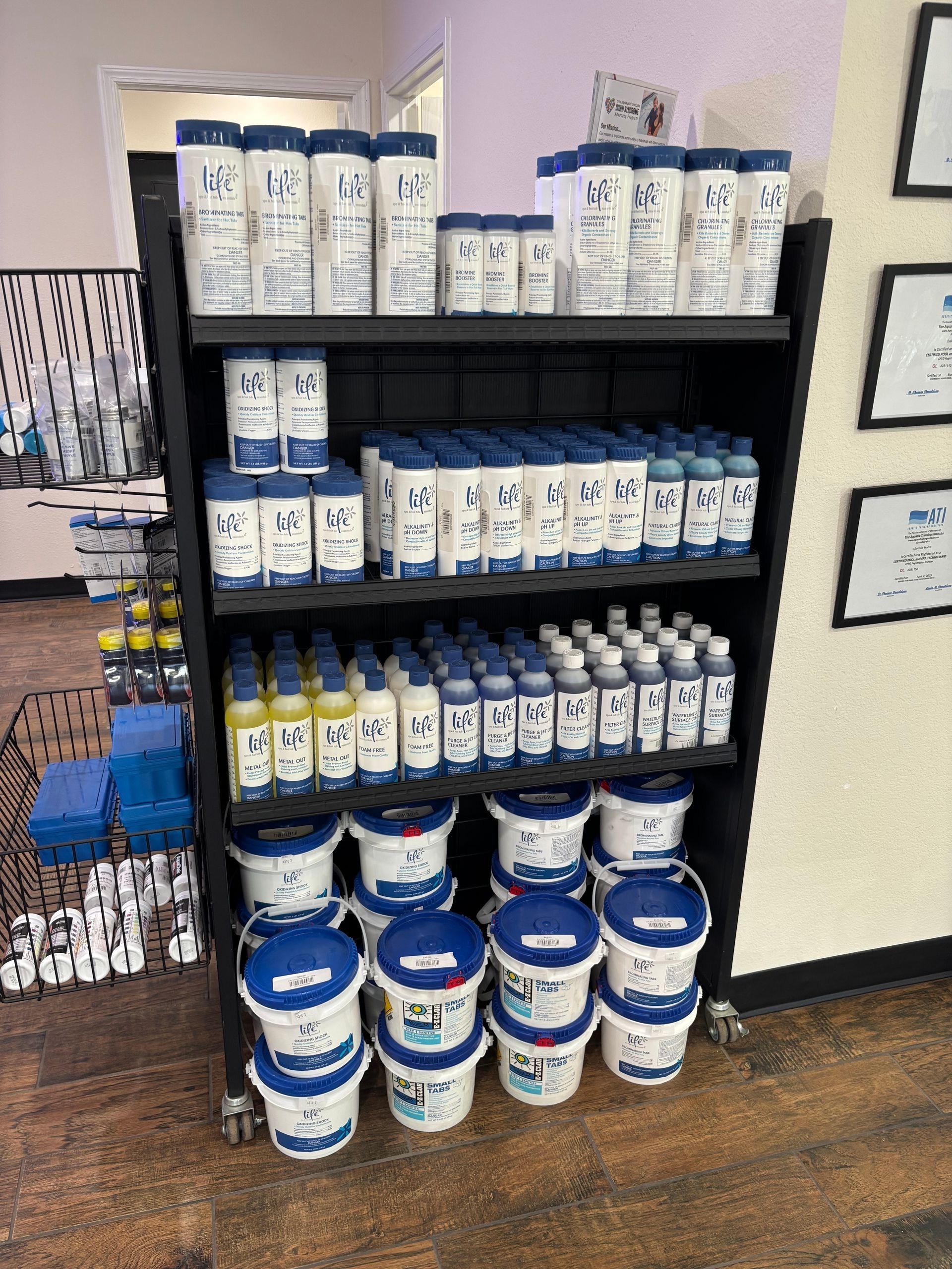 Shelves of blue-and-white paint or sealant cans in a store aisle