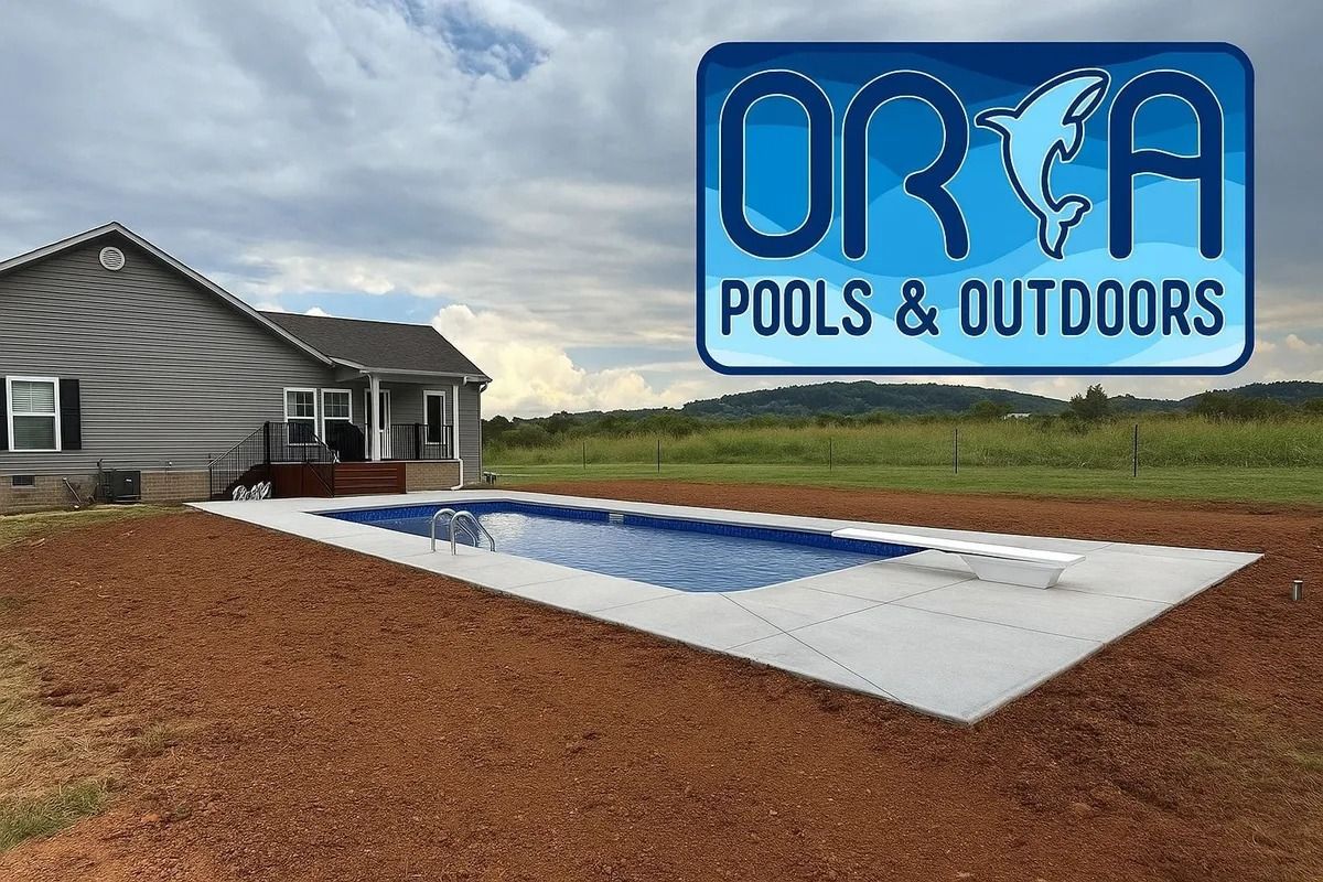 Backyard lap pool with ORA Pools & Outdoors logo overlaid, beside a house on a rural lot