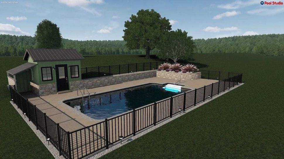 Backyard pool surrounded by a wooden deck and black fence, with a small shed and trees in the background