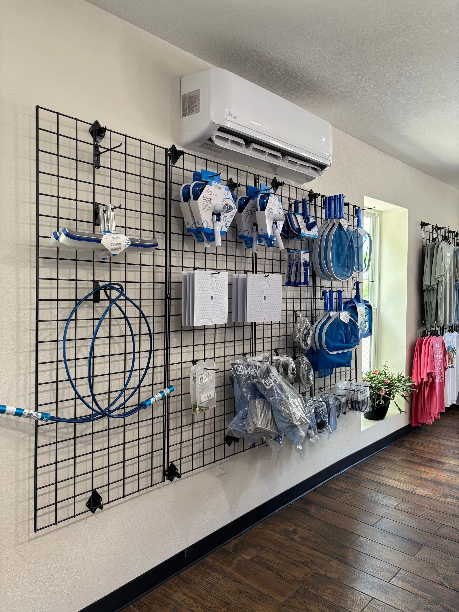 Wall-mounted medical supply display with blue hoses, masks, and accessories in a clinic hallway