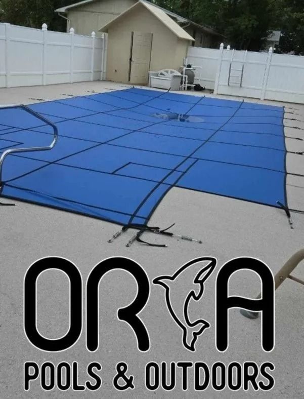 Blue pool cover stretched over a backyard pool, with ORCA Pools & Outdoors logo at bottom